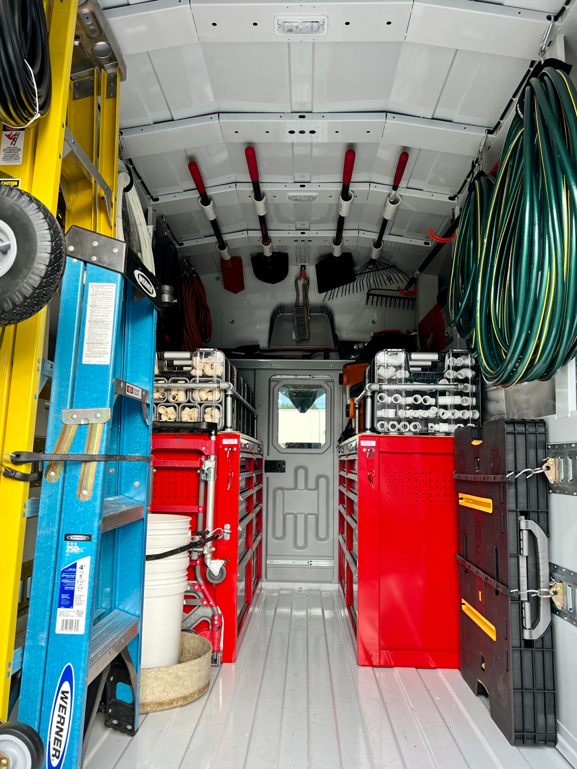 Inside a Gulfview service truck with organized parts cases, red tool cabinets, ladders and overhead tools