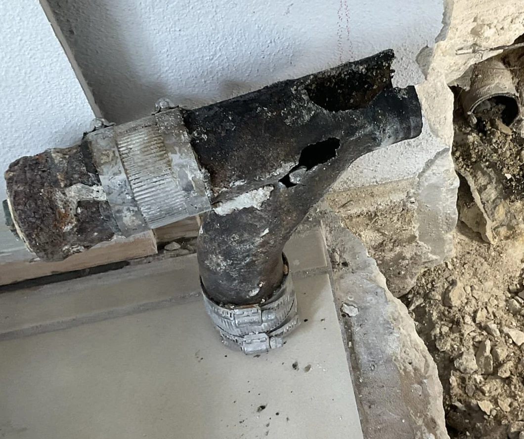 Read the cast-iron kitchen drain replacement story showing the damaged fitting