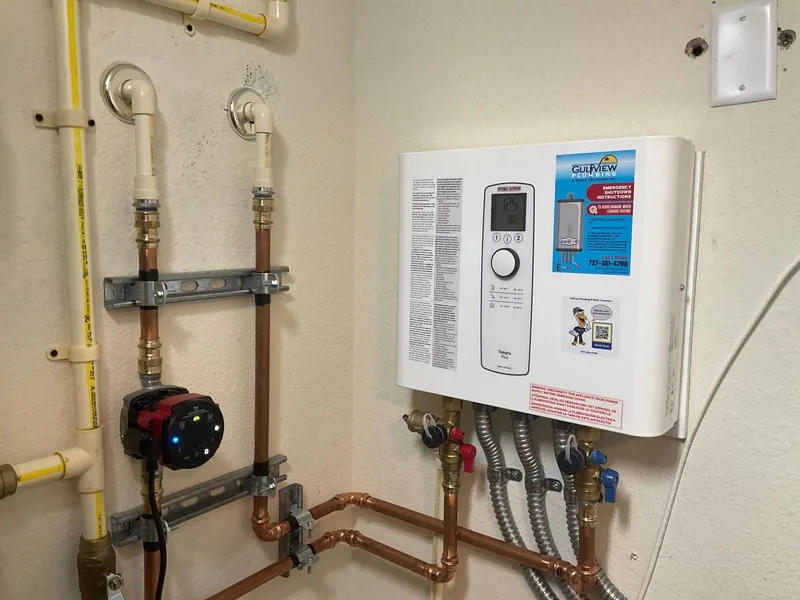 Wall-mounted electric tankless water heater with copper piping and circulation pump