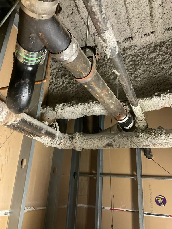 Drain pipe and coupling connections above an open suspended ceiling