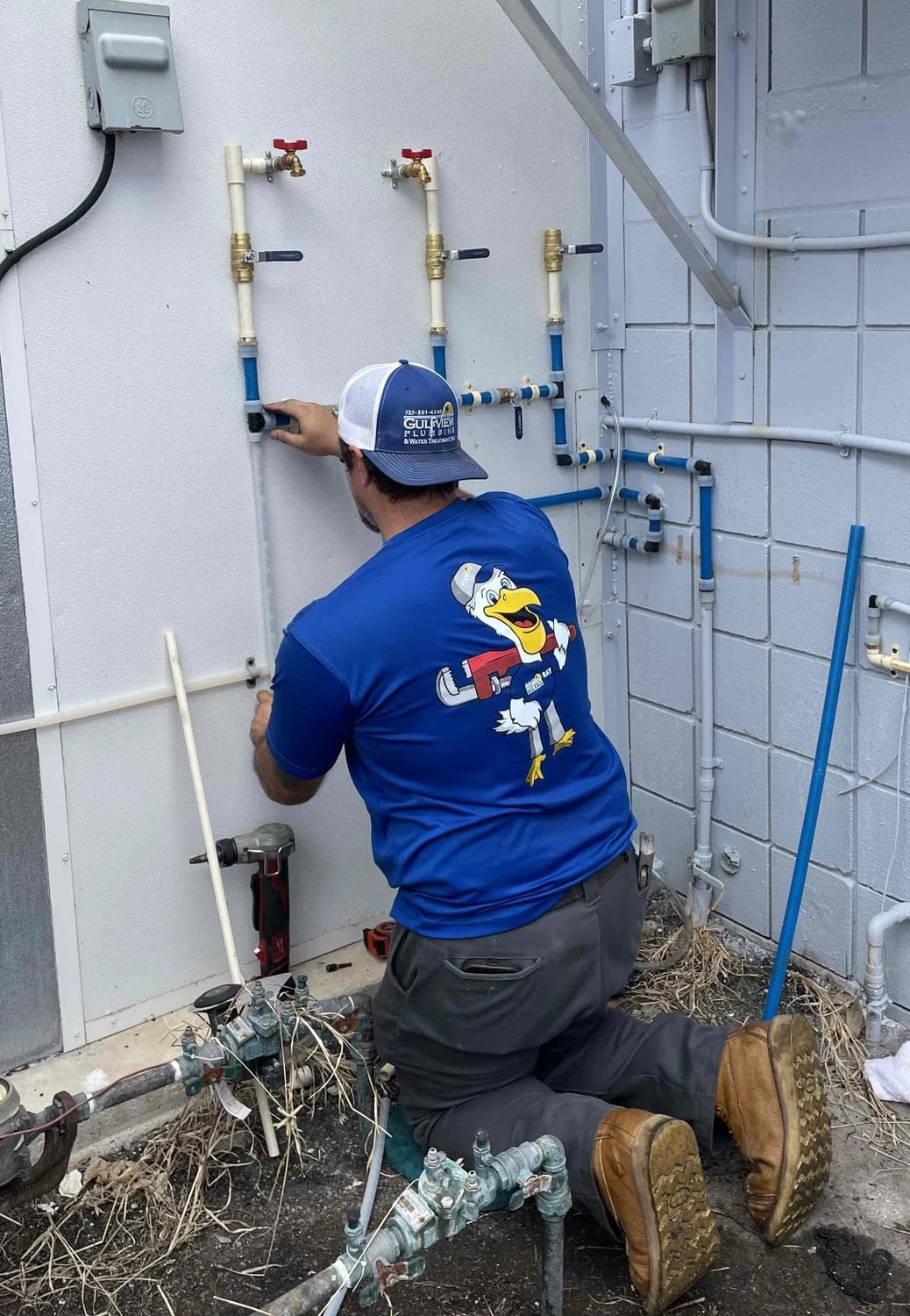 Gulfview technician connecting exterior piping for the restaurant filtration installation
