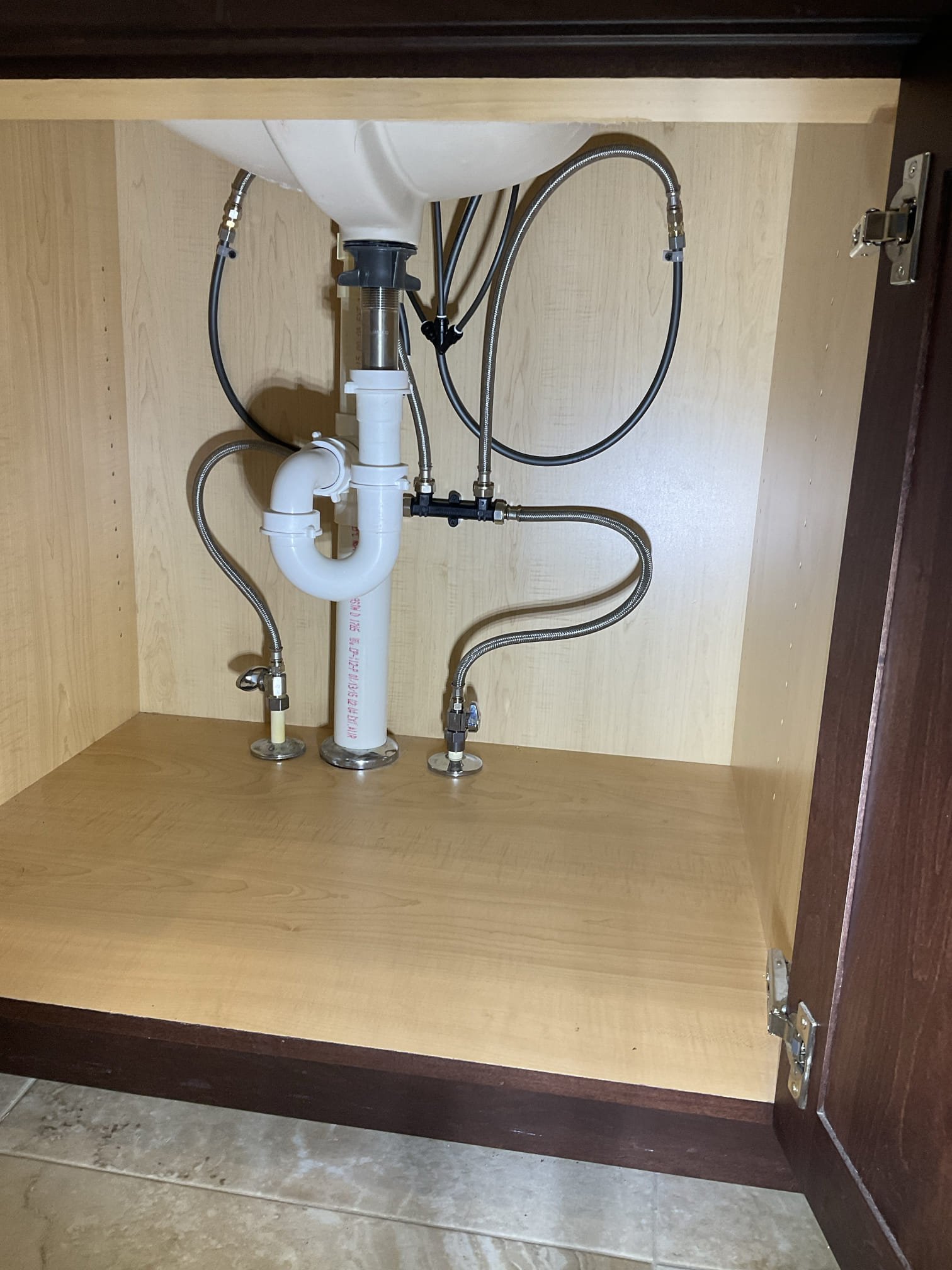 Under-sink crossover valve connecting hot and cold supply lines for a Rinnai recirculation system