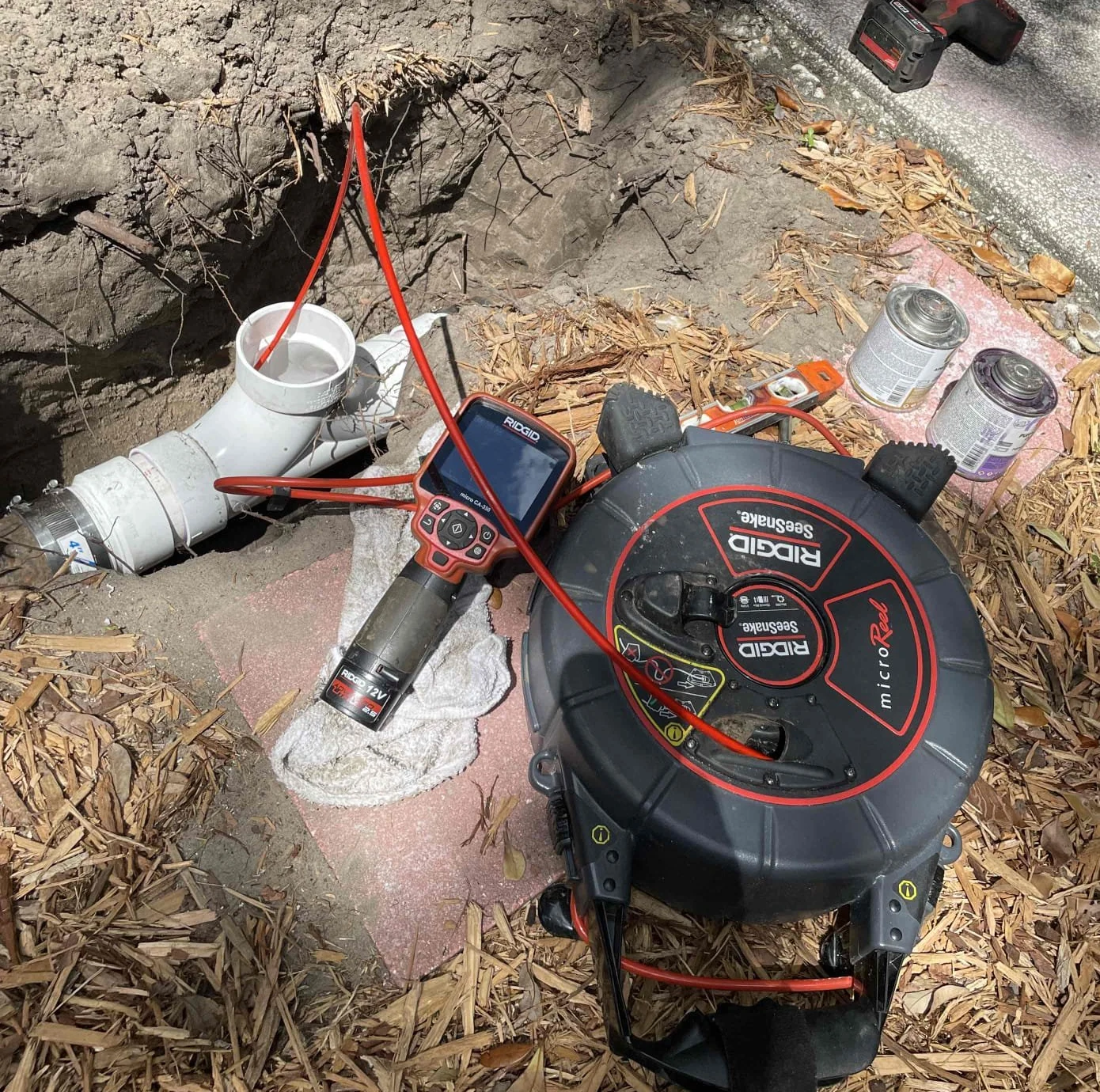 Sewer camera equipment beside cleanout piping at the utility-crossing project