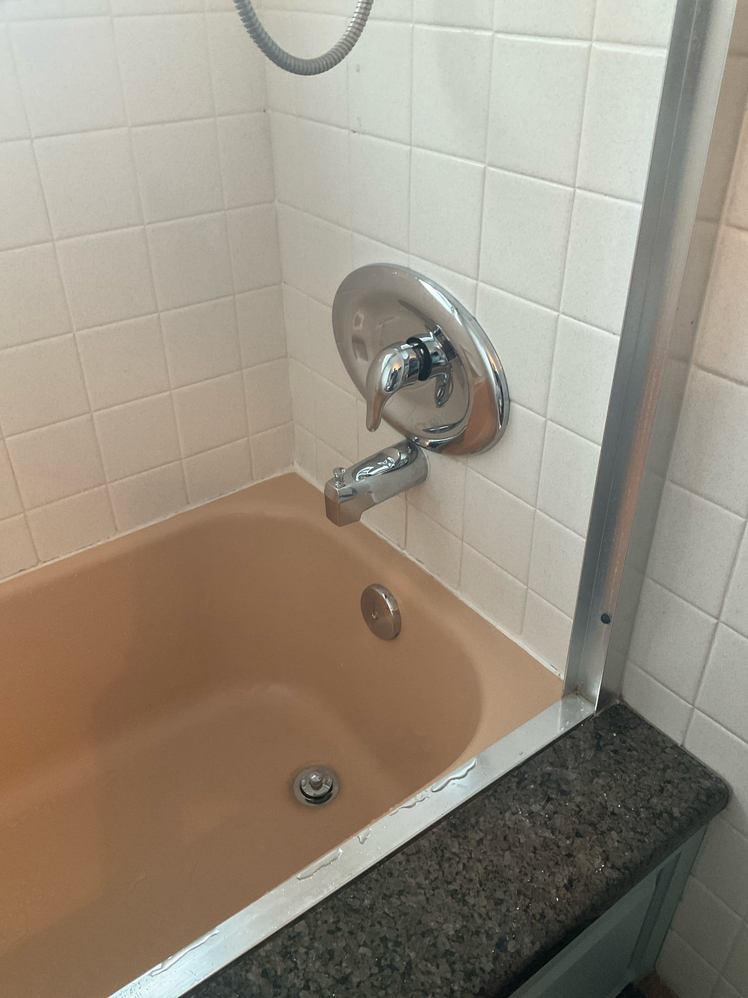 Chrome single-handle shower control with oval cover plate and tub spout