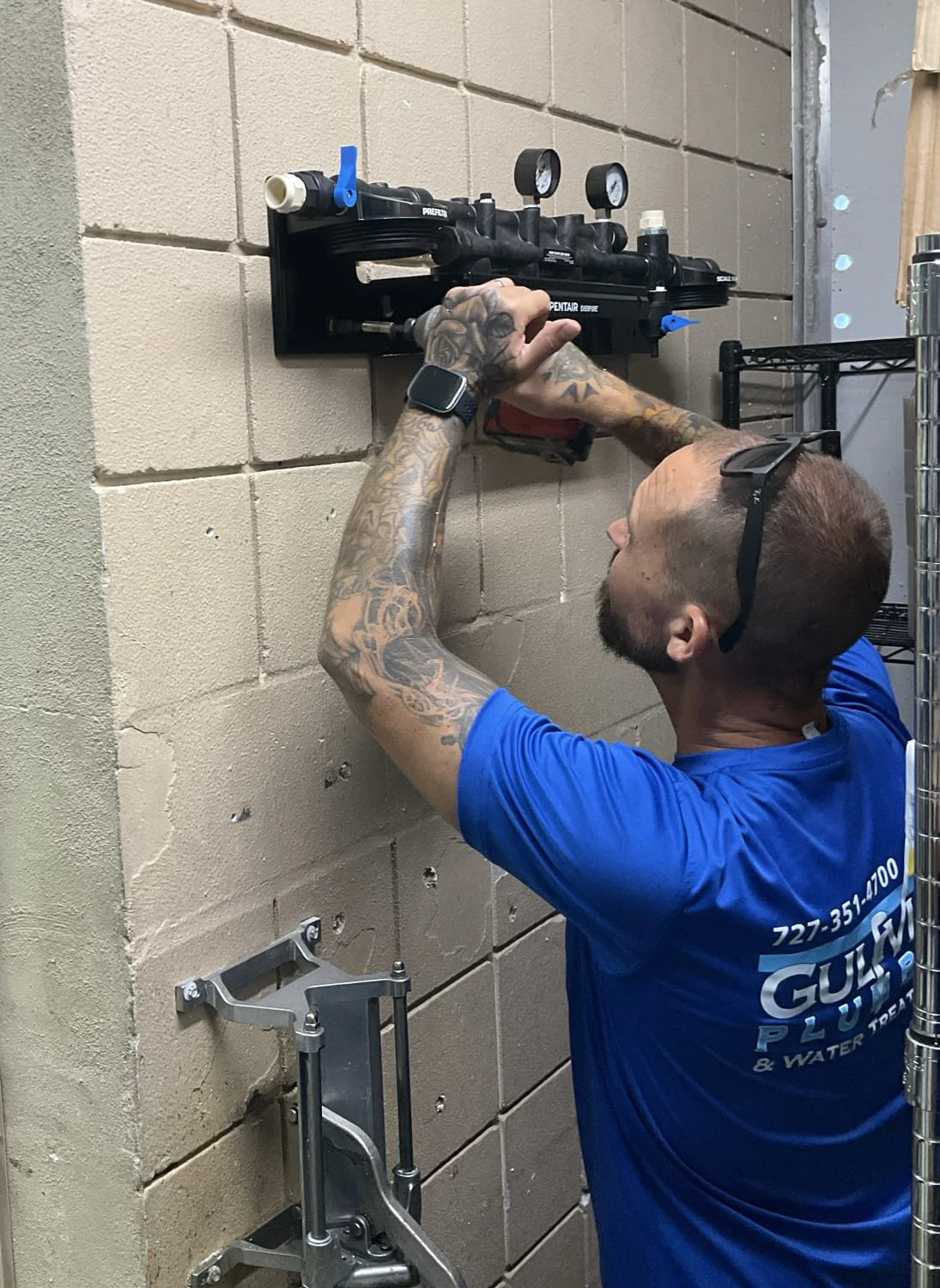 Gulfview technician mounting the Everpure filtration manifold on the restaurant block wall