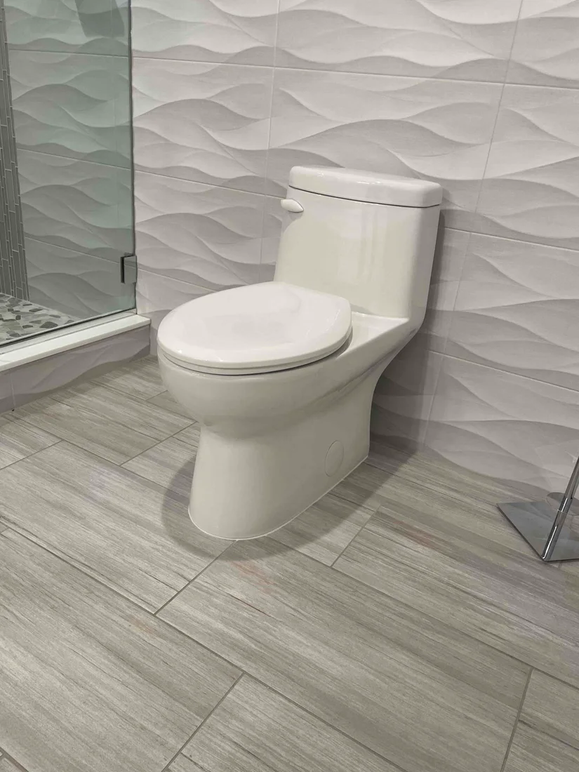 Installed white toilet in a tiled bathroom