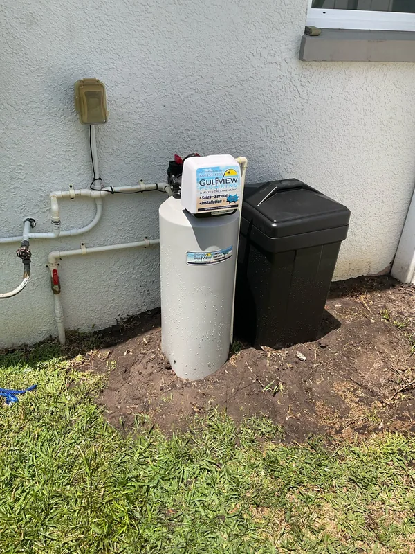 Gulfview-branded softener tank and separate brine cabinet beside an exterior wall