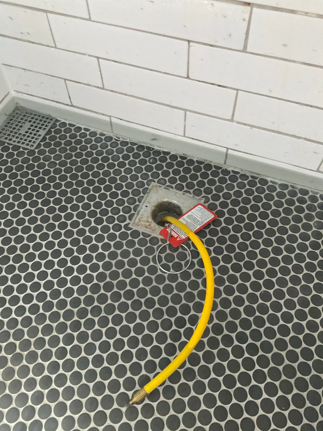 Equipment in a shower drain during Gulfview testing for a suspected shower pan leak